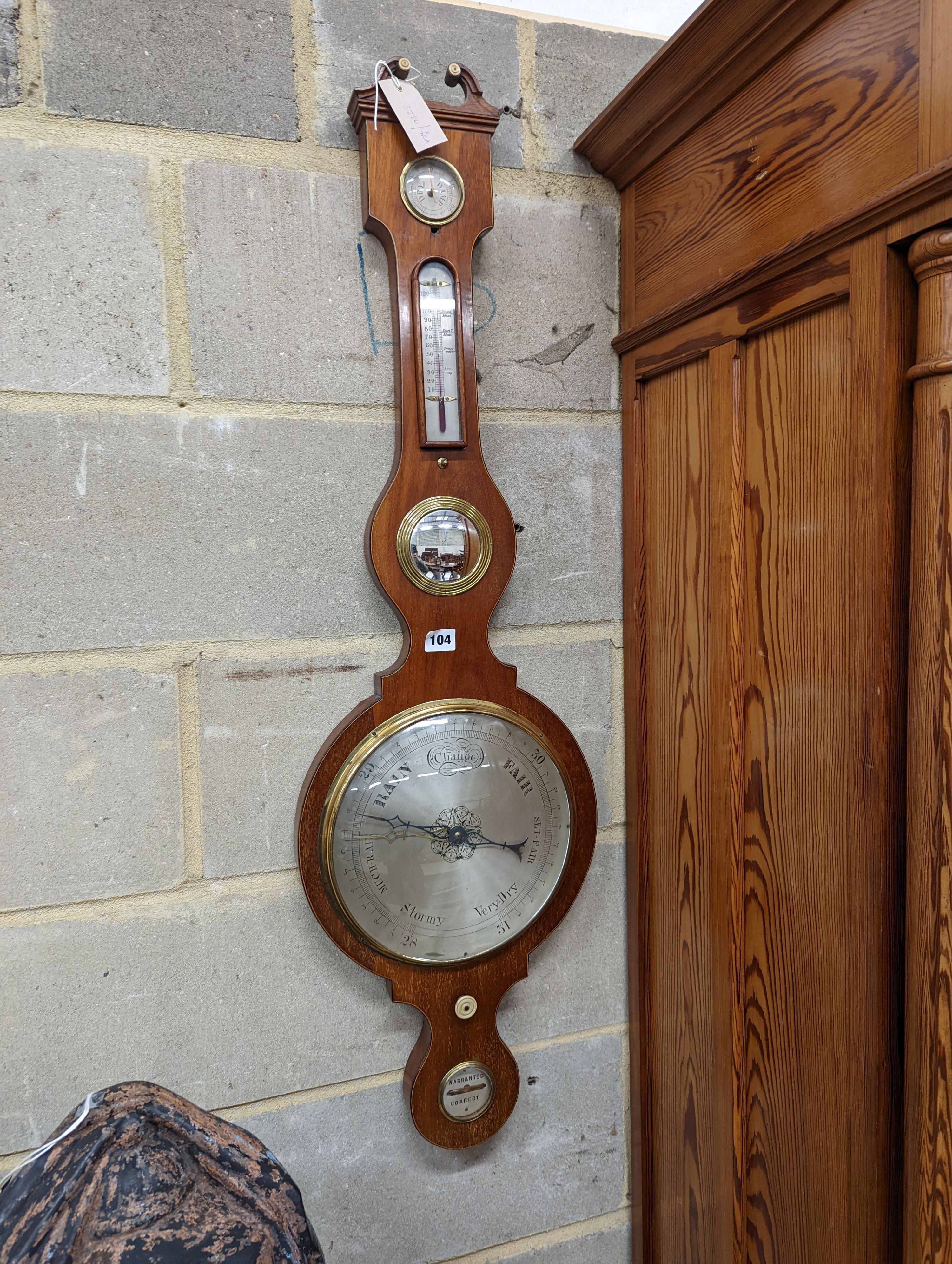 A mahogany wheel barometer. Length -107cm, W-32cm.